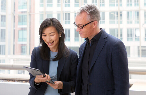 Man and woman looking at a tablet Man and woman looking at a tablet