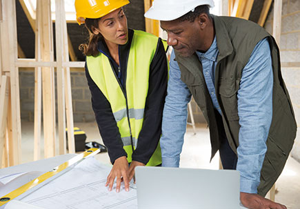 Workmen going over plans Workmen going over plans