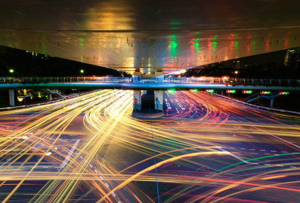 Road at night, with car lights forming light lines