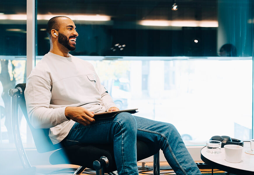 Relaxed, smiling man, sitting in an office