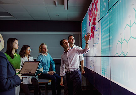Man demonstrating work on large screens Man demonstrating work on large screens