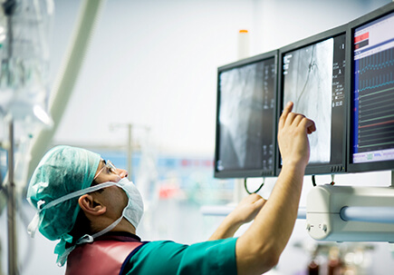Doctor in surgery working on screens