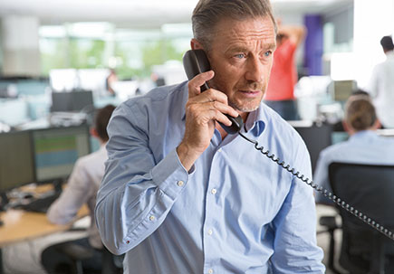 Man on landline in call centre. 