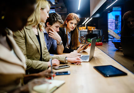 People sat in front of monitors People sat in front of monitors