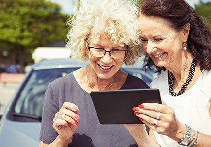 Women on a tablet outside Women on a tablet outside