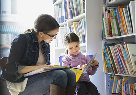 Woman and child reading together. Woman and child reading together.