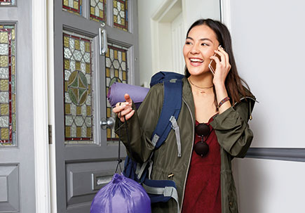 Woman on mobile leaving the house. Woman on mobile leaving the house.