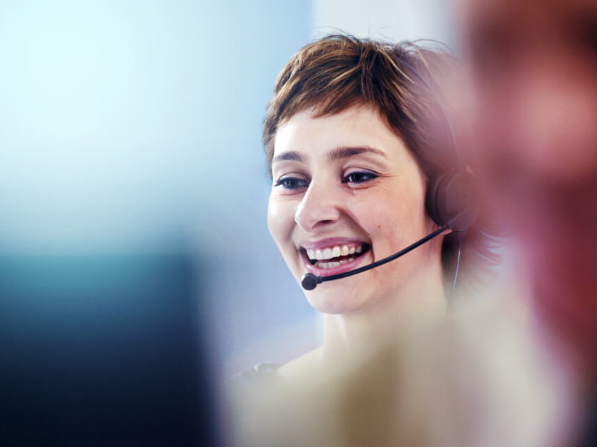 Account manager on a headset talking to customers Account manager on a headset talking to customers