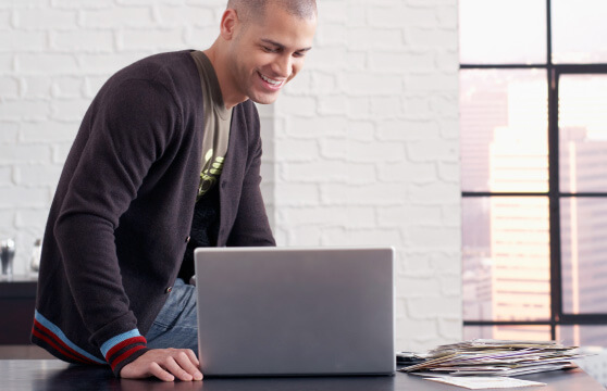 A content man pleased with what he’s seeing on his laptop A content man pleased with what he’s seeing on his laptop